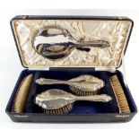 A silver backed brush and mirror set cased, Birmingham 1919