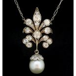 An Edwardian yellow and white gold pendant set diamonds with pearl drop on white metal chain,