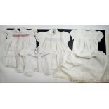 A box of vintage and Edwardian children's baby clothes including christening gown, yellow velvet