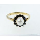 A 9 carat gold pearl and sapphire cluster ring, size O, 2g