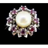 A 14 carat white gold ring set pearl within rubies, size P