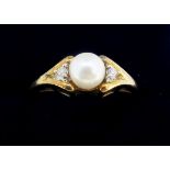 A 9 carat gold ring set pearl flanked by diamond chips, size N, 2.5g