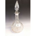 A cut glass decanter with silver collar