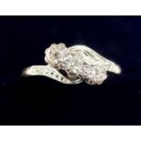 An 18 carat gold three stone illusion set diamond ring, size S, 3.2g