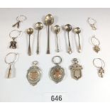 Six silver cruet spoons and a set of six silver plated drinks charms and three silver sports medals