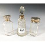 A cut glass and silver scent bottle and two cut glass and silver toiletry bottles