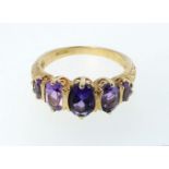 A 9ct gold ring set five amethysts, size N, 3g