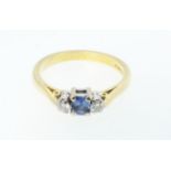 An 18ct gold Art Deco style ring set with central sapphire and flanking diamonds, size O 1/2, 4g