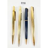 Three gold plated pencils and a Parker propelling pencil