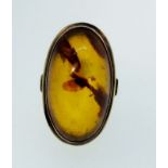 A yellow metal "333" standard oval amber ring, size N/Q