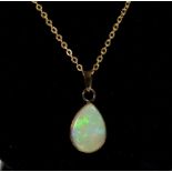A 9 carat gold tear drop form opal pendant on gold plated chain