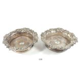 A pair of silver plated and wooden bottle coasters with vine borders, 19cm diameter
