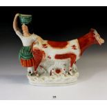 A Staffordshire pottery figure of a girl with cow, 24cm high