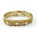 A fine quality 18 carat white and yellow woven gold bracelet set rubies and pearls, 49g