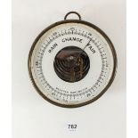A brass backed marine barometer by Taylor of Rochester, New York