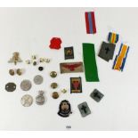 A box of military badges and shooting medals including cap badges, buttons, RAF etc.