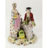 A late 19thC German porcelain figural group of a couple with baby, crossed arrows mark to rear