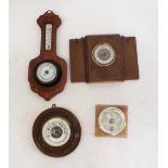 A selection of four aneroid barometers to include one circular carved oak barometer, one with Art