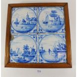 Four Delft blue and white tiles framed and mounted as a stand