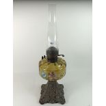 A Victorian oil lamp with painted glass reservoir and metal base - 56cm