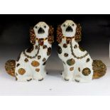 A pair of 19thC Staffordshire spaniels with copper lustre decoration, 33cm