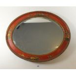 A Japanese red laquer framed oval mirror - 50 x 40cm