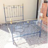 A Victorian brass bedstead with fleur de lys decoration (two missing castors) with irons 4ft 6"