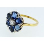 An 18 carat gold sapphire and diamond flower form cluster ring, size N/O, 4g