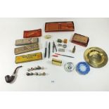 A box of collectables including trench art cigarette lighter and matchbox holder, Peterson pipe etc.