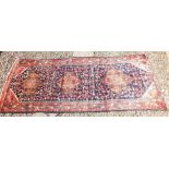 A large blue ground Persian Sarouk runner with medallion design - 286 x 105cm