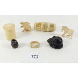 A 19th century ivory reel holder, bone set of miniature dominoes in carved cased two bone animals