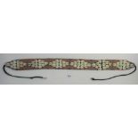 A tribal beadwork and cowrie shell belt