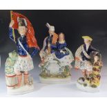 Three 19thC Staffordshire pottery figures of Scottish Highland dancers, largest 41cm
