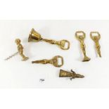 Four novelty nude brass bottle openers, corkscrew etc.