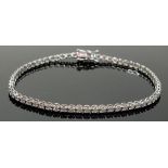 An 18 carat white gold diamond line bracelet set with 62 round brilliant cut diamonds, approx length