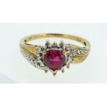 A 10ct gold ring set with heart shaped ruby and flanking diamonds, size Q, 2.5g