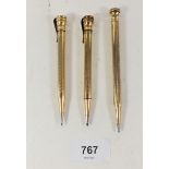 Three gold plated pencils