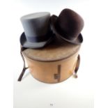 A Wilson and Stafford top hat together with a bowler hat in a large hat box