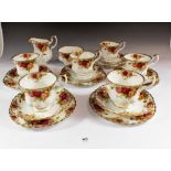 A Royal Albert Country Roses tea service comprising: six cups and saucers, six tea plats, milk and