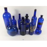 A quantity of Bristol blue apothecary and other glass bottles