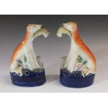 A pair of small 19thC Staffordshire figures of greyhounds with hares in mouth, 14cm
