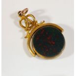 An antique yellow metal swivel fob set with bloodstone