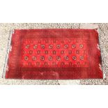 A Turkoman red ground rug - 192 x 105cm