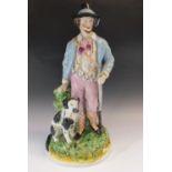 A large 19thC Stafforshire figure of a hunter and dog, 42cm