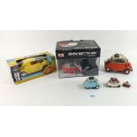 A group of three model Bubble cars and a Beetle