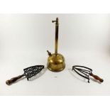 A 19th century brass oil lamp base and two iron trivets