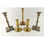 A pair of Georgian brass candlesticks, a column form one and a pair of early stamped metal