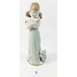 A Lladro figure of a girl with kittens