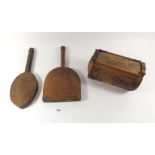 A carved bamboo box and two ethnic carved wood paddles