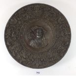 A 19thC cast iron decorative circular plaque, possibly Russian, embossed in a Baroque style with